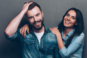 Man and woman smiling with new haircuts