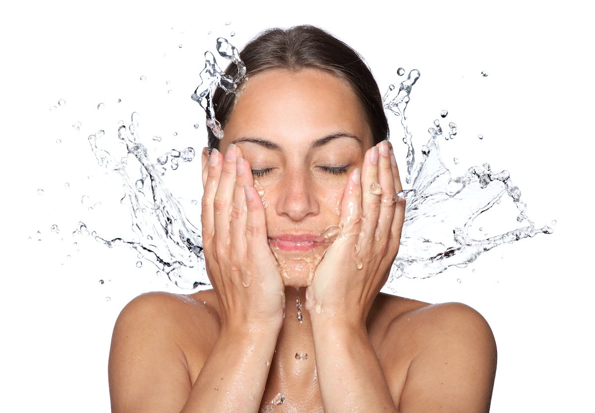 Woman splashing water on her face